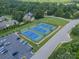 Aerial view of well-maintained blue and green tennis courts with ample parking and surrounding trees in a community setting at 1543 Withers Dr, Denver, NC 28037