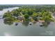 Aerial view of lakefront properties featuring well-manicured lawns and private boat docks at 173 Riverwood Rd, Mooresville, NC 28117