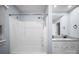Bathroom with granite countertop vanity and shower/tub combo with white tile surround at 173 Riverwood Rd, Mooresville, NC 28117