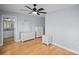 Bedroom featuring light blue walls and wooden floors, as well as white dresser and night stand at 173 Riverwood Rd, Mooresville, NC 28117