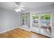 Bright bedroom boasts a ceiling fan, hardwood floors, and sliding glass doors to the outdoors at 173 Riverwood Rd, Mooresville, NC 28117