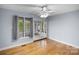 Bedroom featuring hardwood floors, ceiling fan, and sliding glass doors that leads to porch and a lake view at 173 Riverwood Rd, Mooresville, NC 28117