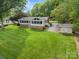 A lush front yard features mature landscaping and complements the home's brick and siding exterior at 173 Riverwood Rd, Mooresville, NC 28117