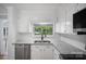 Well-lit kitchen showcases stainless steel appliances and granite countertops with water view at 173 Riverwood Rd, Mooresville, NC 28117