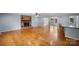 Open-concept living space with hardwood flooring, fireplace and waterfront views at 173 Riverwood Rd, Mooresville, NC 28117