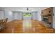 Sunlit living room featuring wood floors, brick fireplace, and scenic outdoor views at 173 Riverwood Rd, Mooresville, NC 28117