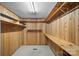 Spacious walk-in closet with wooden walls, carpeted floor, and sturdy built-in shelving at 173 Riverwood Rd, Mooresville, NC 28117