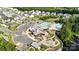 Overhead view of community pool, clubhouse, playground, parking, and lush landscaping among well-kept residences at 1908 Masons Bend Dr, Fort Mill, SC 29708