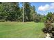 Expansive backyard featuring lush green grass and mature trees offering privacy at 1908 Masons Bend Dr, Fort Mill, SC 29708