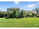 Lush backyard with a well-maintained lawn and beautiful landscaping at 1908 Masons Bend Dr, Fort Mill, SC 29708