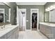 Bathroom with dual sinks, modern cabinetry, and access to closet and additional rooms at 1908 Masons Bend Dr, Fort Mill, SC 29708