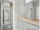 Bright bathroom featuring a white vanity and shower with gray tiling and glass door at 1908 Masons Bend Dr, Fort Mill, SC 29708