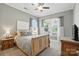 Comfortable bedroom with neutral colors, wood furniture, and lots of natural light at 1908 Masons Bend Dr, Fort Mill, SC 29708