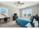 Well-lit bedroom featuring a desk, dresser, ceiling fan, and comfortable furnishings at 1908 Masons Bend Dr, Fort Mill, SC 29708