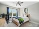 Cozy bedroom with a ceiling fan, large window with drapes, and modern decor at 1908 Masons Bend Dr, Fort Mill, SC 29708