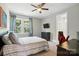 Bedroom with natural light, ceiling fan, TV, and comfortable furnishings with ensuite bathroom at 1908 Masons Bend Dr, Fort Mill, SC 29708
