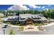Beautiful clubhouse with a metal roof, stone accents, and wooden doors, surrounded by a landscaped parking area at 1908 Masons Bend Dr, Fort Mill, SC 29708