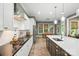 Open kitchen with white cabinetry, dark countertops, and a view into the adjacent dining area at 1908 Masons Bend Dr, Fort Mill, SC 29708