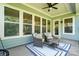 Inviting covered patio featuring comfortable wicker seating and a ceiling fan at 1908 Masons Bend Dr, Fort Mill, SC 29708