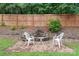 Brick paver patio with a water feature and chairs, all surrounded by a wood fence and lush greenery at 231 Anvil Draw Pl, Rock Hill, SC 29730