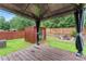 View from the deck showcasing a storage shed, gazebo, a well-maintained lawn, and wooden fencing at 231 Anvil Draw Pl, Rock Hill, SC 29730