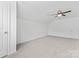 Bright bedroom with neutral walls, light-colored carpet, a ceiling fan, and a door at 231 Anvil Draw Pl, Rock Hill, SC 29730