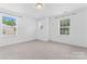 Bright bedroom with carpet, neutral walls, three windows, and a ceiling light at 231 Anvil Draw Pl, Rock Hill, SC 29730