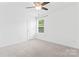 Bright bedroom with neutral walls, light-colored carpet, a window with blinds, and a ceiling fan at 231 Anvil Draw Pl, Rock Hill, SC 29730