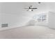 Bright bonus room with neutral carpet, ceiling fan, and natural light streaming through the windows at 231 Anvil Draw Pl, Rock Hill, SC 29730