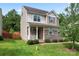 Charming two-story home with stone accents, a cozy front porch, and a well-maintained lawn at 231 Anvil Draw Pl, Rock Hill, SC 29730