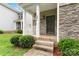 Inviting front porch with stone accents, a white railing, and neatly trimmed shrubs at 231 Anvil Draw Pl, Rock Hill, SC 29730