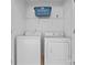 Bright laundry room with modern washer and dryer, as well as wire rack storage at 231 Anvil Draw Pl, Rock Hill, SC 29730
