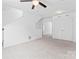 A living room with neutral carpet, a ceiling fan, and large closet with double doors at 231 Anvil Draw Pl, Rock Hill, SC 29730