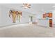 Open-concept living room features a ceiling fan and seamlessly connects to the kitchen at 231 Anvil Draw Pl, Rock Hill, SC 29730