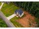 An aerial view of a newly constructed home with a lawn and tree line at 236 Mark Ryan Ln, Dallas, NC 28034
