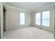 Spacious bedroom featuring ample natural light from large windows, awaiting final touches at 236 Mark Ryan Ln, Dallas, NC 28034