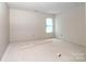 Sunlit bedroom with large windows, awaiting flooring and finishing to create a cozy space at 236 Mark Ryan Ln, Dallas, NC 28034