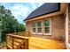 Lovely deck area with brick, railing, and view of the tree line at 236 Mark Ryan Ln, Dallas, NC 28034