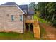 Back exterior of house with light brick, deck, and stairs to yard at 236 Mark Ryan Ln, Dallas, NC 28034