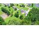 Aerial view of a property with large lawn, trees, fire pit, playset, house and outbuilding at 250 Wesley Amaker Rd, York, SC 29745