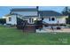 Spacious backyard with a deck, patio with fire pit, and lush lawn for outdoor entertainment at 250 Wesley Amaker Rd, York, SC 29745