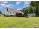 Lush backyard featuring a deck, fire pit, and a storage shed at 250 Wesley Amaker Rd, York, SC 29745
