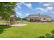 Spacious backyard featuring a playset, expansive lawn, and the house with a wooden deck at 250 Wesley Amaker Rd, York, SC 29745