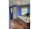 Bathroom showing a tub with unique tile work and a window at 250 Wesley Amaker Rd, York, SC 29745