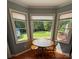 A sunny breakfast nook with a small table, natural light from the windows, and a view of the back yard at 250 Wesley Amaker Rd, York, SC 29745
