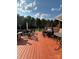 Red wooden deck, BBQ, seating, and backyard view, great for entertaining guests at 250 Wesley Amaker Rd, York, SC 29745
