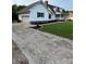 Spacious driveway leading to a charming home with a garage, lush lawn, and well-manicured landscaping at 250 Wesley Amaker Rd, York, SC 29745