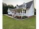 Charming home with a covered front porch, an American flag, and well-maintained landscaping at 250 Wesley Amaker Rd, York, SC 29745