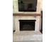 Close-up of the brick fireplace with a wood mantle and a mounted television above at 250 Wesley Amaker Rd, York, SC 29745
