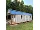 Gray outbuilding with blue metal roof, porch and double doors at 250 Wesley Amaker Rd, York, SC 29745